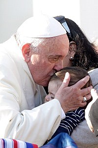 VATICAN CITY, VATICAN - DECEMBER 18: Pope Francis kisses a child as he arrives at his weekly Audience in St. Peter's Square on December 18, 2013 in Vatican City, Vatican. During the Audience the Holy Father turned his attention to the Feast of the Nativity: 'this our encounter,' he said, 'is taking place in the spiritual climate of Advent, made even more intense by the Novena of the Holy Nativity that we are living in these days.' (Photo by Franco Origlia/Getty Images)